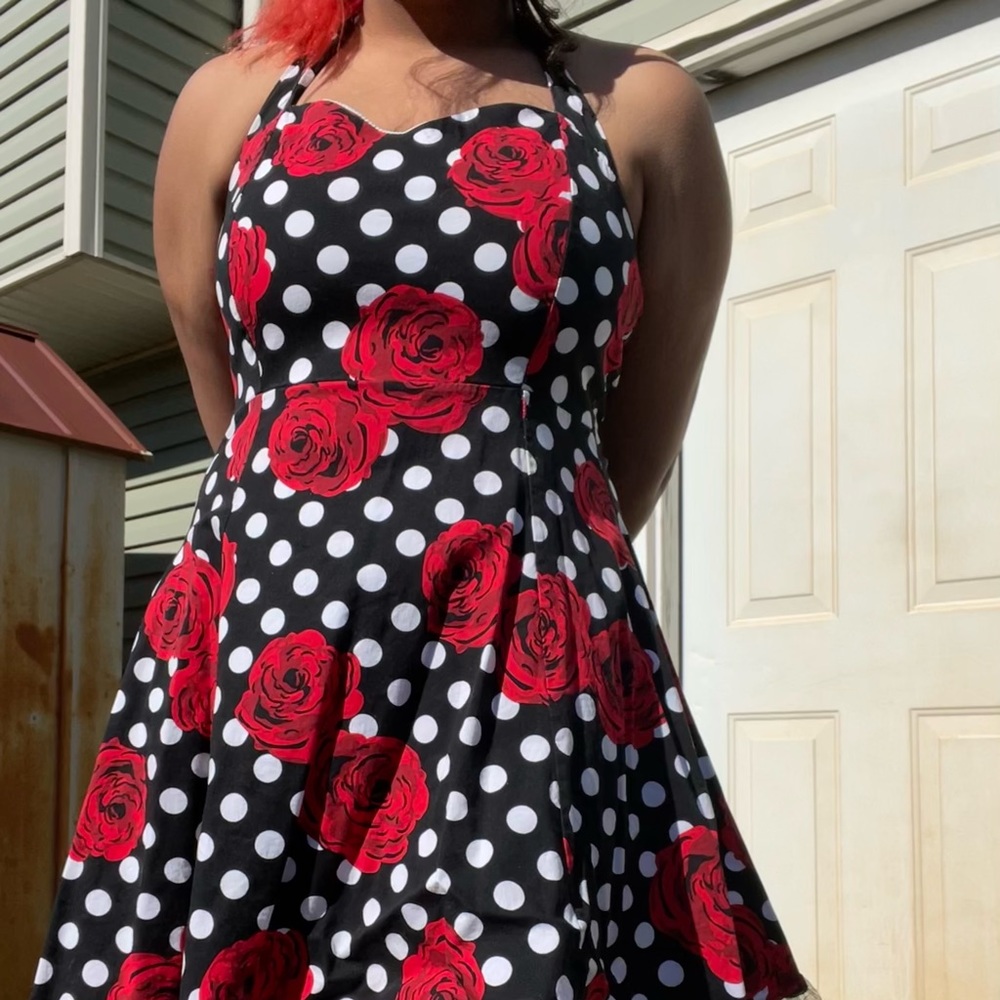 Hello! I am selling a black dress with white polka dots and red roses.